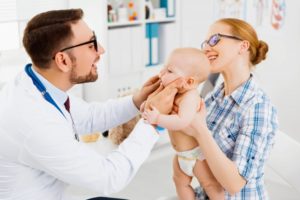 baby being examined for tongue-tie treatment