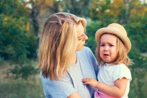 mom comforting upset toddler