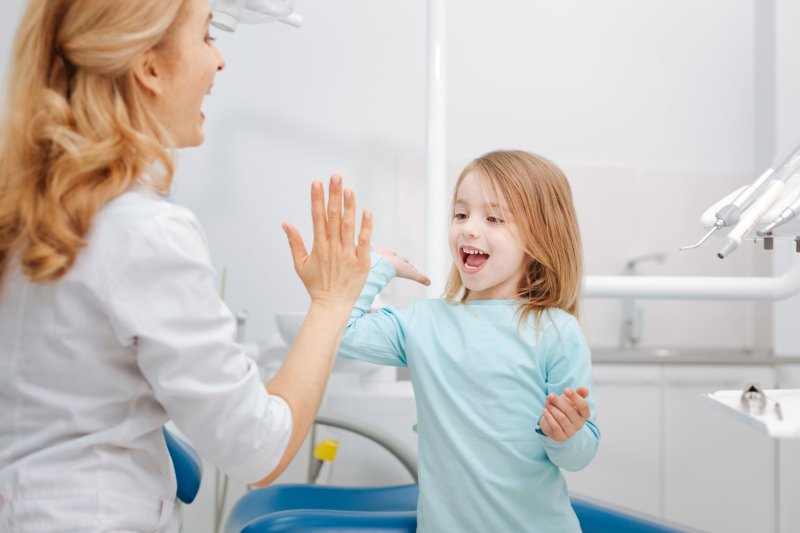 child talking excitedly to their dentist