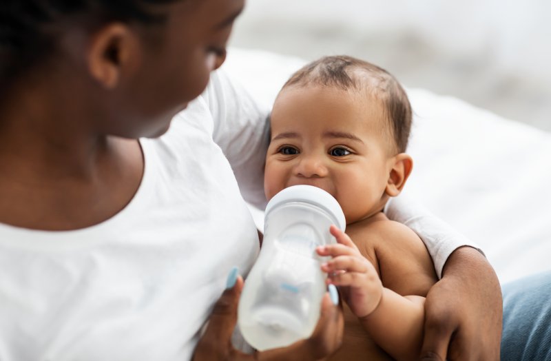 baby holding a bottle