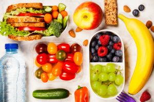 Birds eye view of assorted fruits and veggies on a marble countertop 