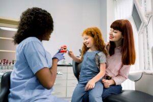 Mother and child interacting with dental team member