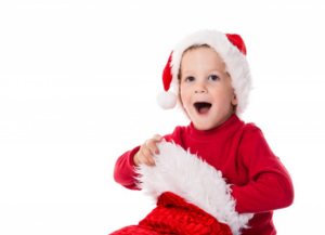 Kid smiling widely as he digs into his stocking