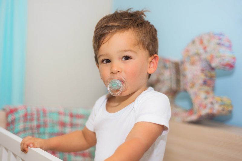 toddler using a pacifier